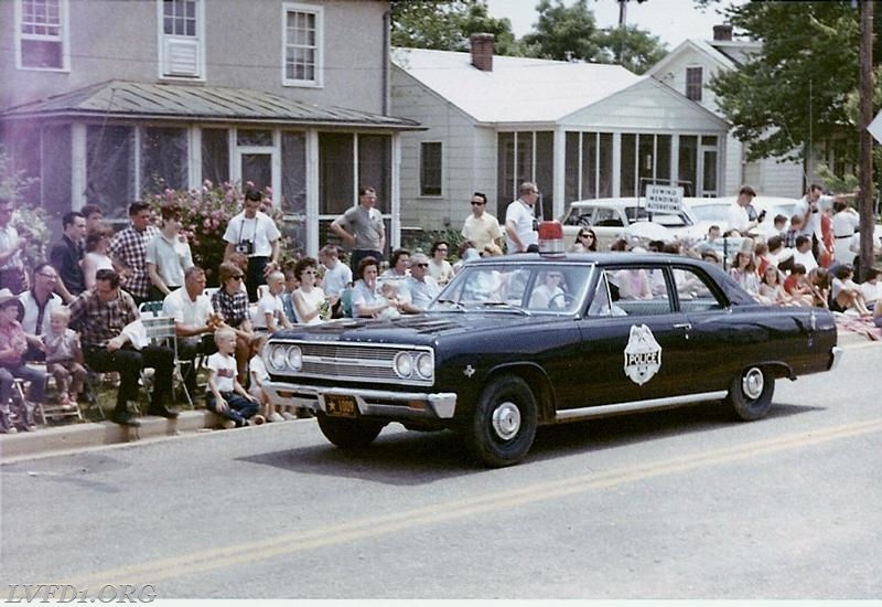 1965:  Leonardtown police car and Police Chief Bea Mattingly parade in Leonardtown Fire Station dedication